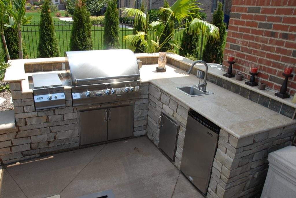 This beautiful outdoor kitchen has a commercial stainless grill