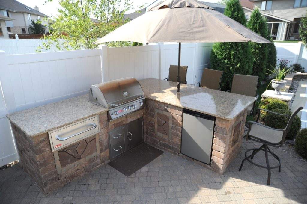 Outdoor kitchen with granite countertop and an umbrella in Orland Park, IL 