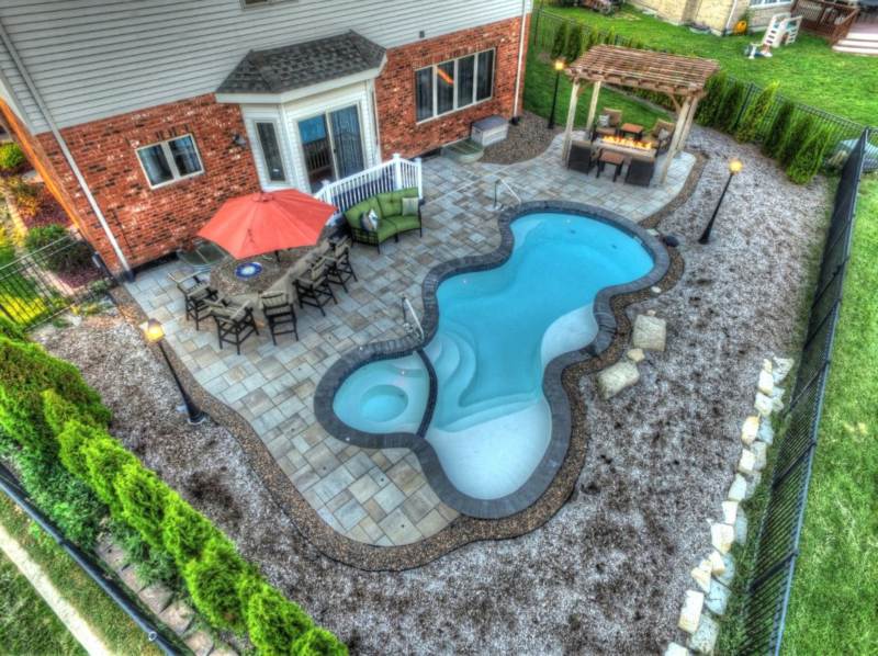 The Desert Springs fiberglass pool with water trickling into the pool in Orland Park, IL