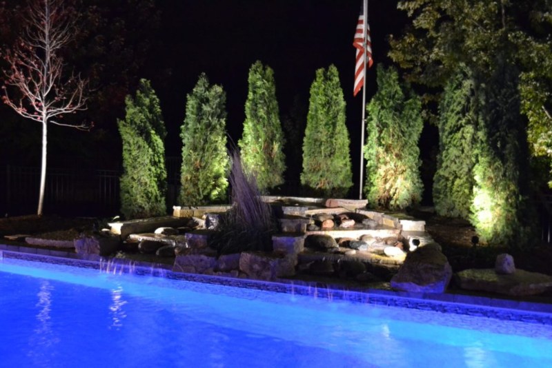 Hardscape Waterfall in night time with us flag at Orland Park, IL