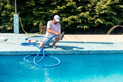 Man cleaning swimming pool in Orland Park, IL